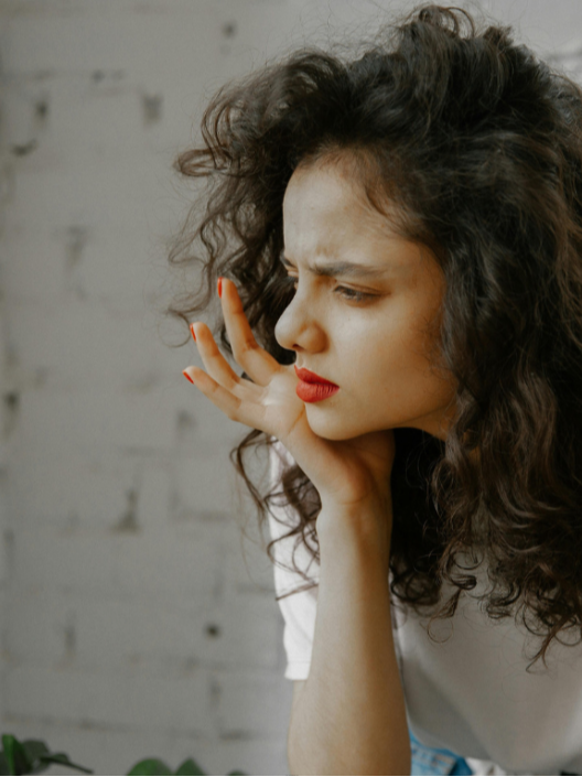 Woman looking uncertain and thoughtful, reflecting anxiety even when life appears to be going well.